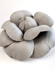 Grey leather camellia brooch with sculptural layered petals and matte finish