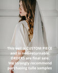 Bride wearing AUGUSTE pearl wedding veil with scattered pearls on soft Italian tulle, modern one-tier bridal look