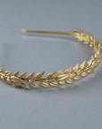 Brass laurel leaves with subtle crystal accents on Alexandra slim gold laurel headband