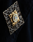 Close-up of filigree and crystal arrangement on VERITAS boutonniere