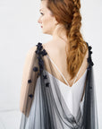 Model wearing SABINE floral cape veil in black, draped across the back