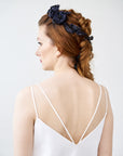 View of a bride with a complex braid hairstyle featuring the FIONA black silk velvet rose crown, showing the flexible integration of hand-sculpted flowers.