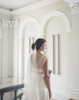 Bride wearing ELIZABETH wedding veil with elegant updo, showing dual comb attachment system