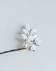Close-up of frosted leaf bridal hair pin with pearls and rhinestones
