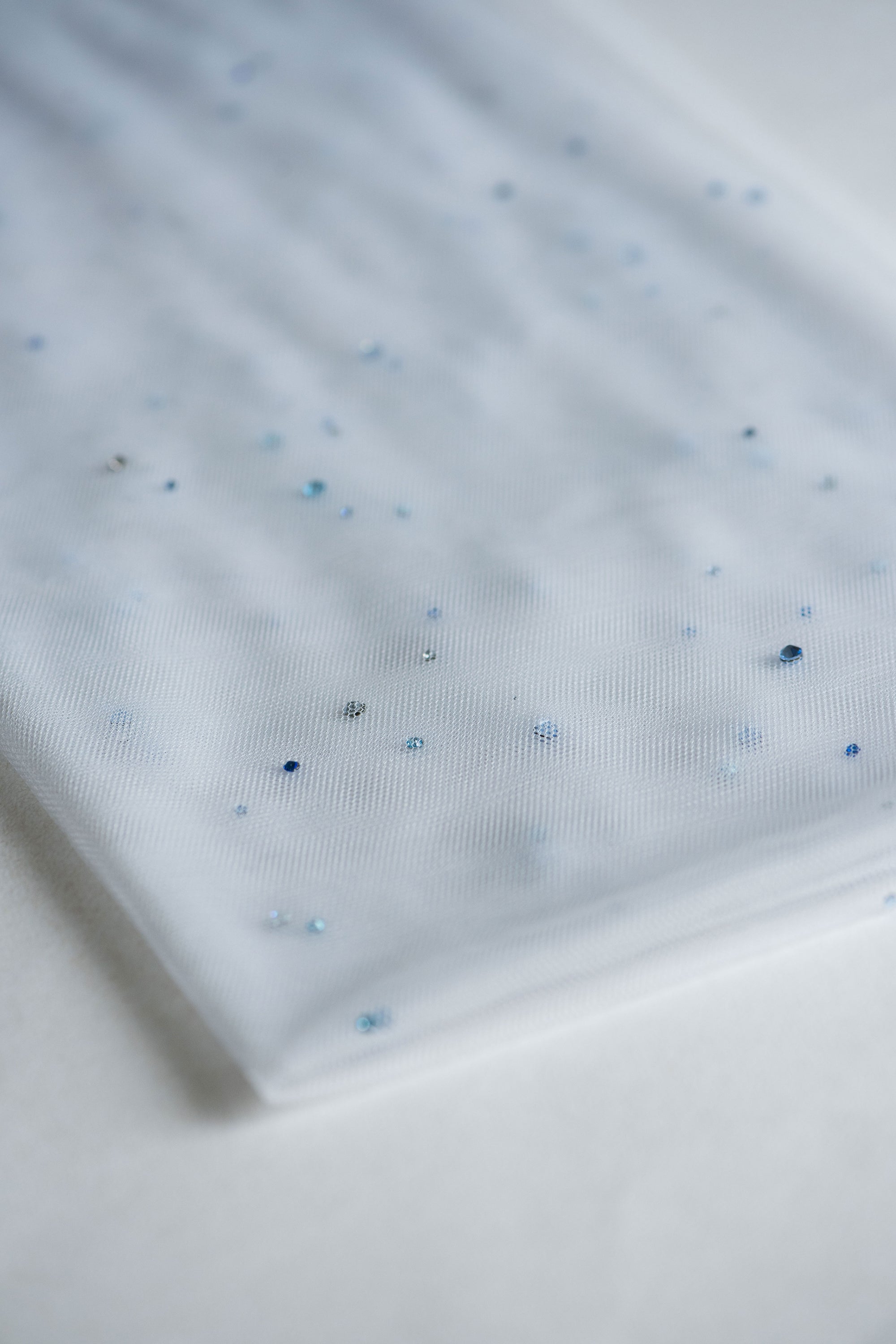 Close-up of blue crystal accents on the Rain Veil, double-sided for a seamless look and arranged to evoke the beauty of falling raindrops.