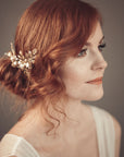 Bride wearing gold leaf and flower hair vine with pearls — TYCHE headpiece