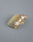 Botanical gold hair comb with leaf and enamel flower design