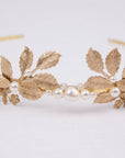 CARPO bridal headband showing the detailed veins of gold brass oak leaves and hand-wrapped ivory pearls on a slim gold wire base.