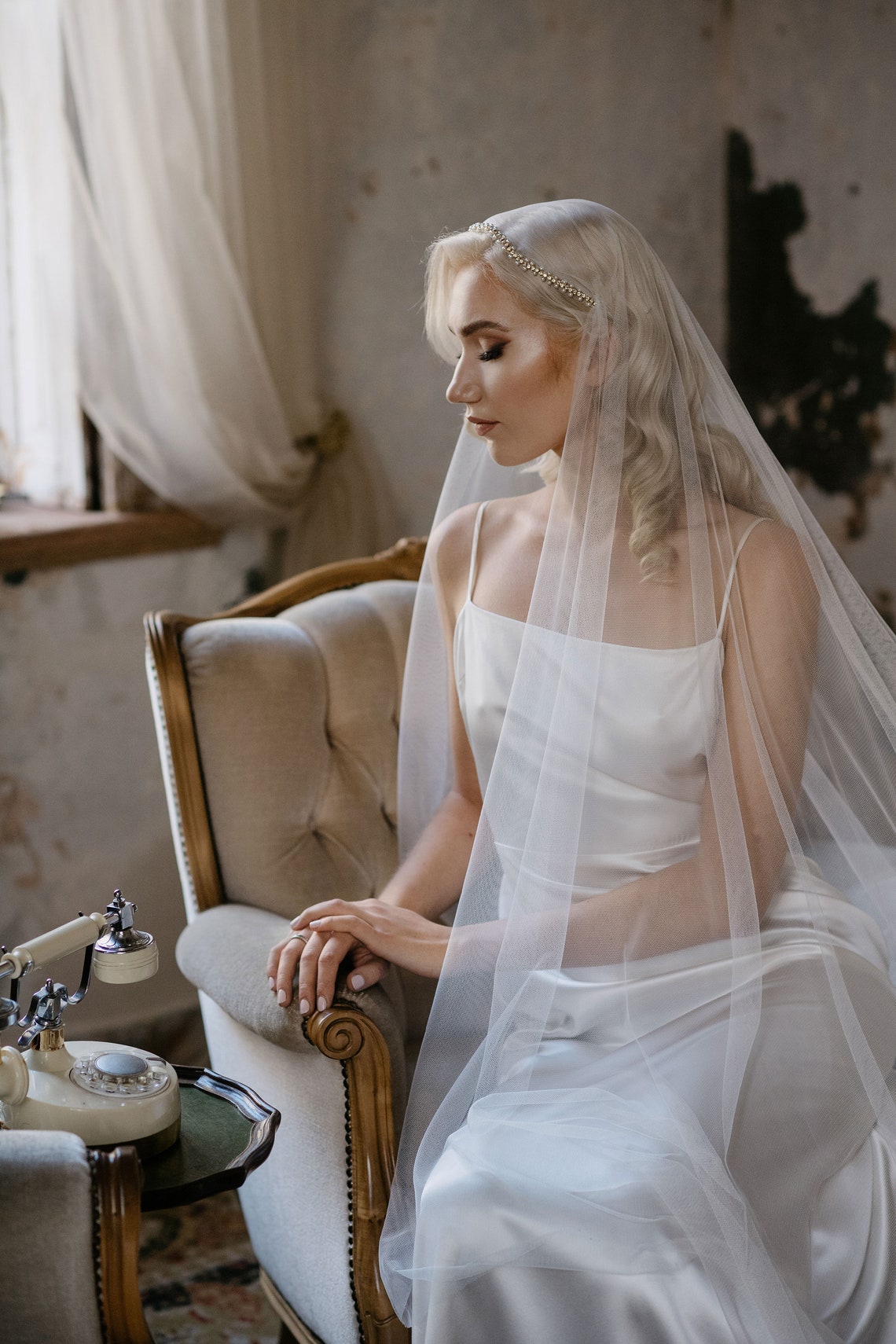 Side view of handmade vintage inspired Juliet cap wedding veil with pearls and crystals
