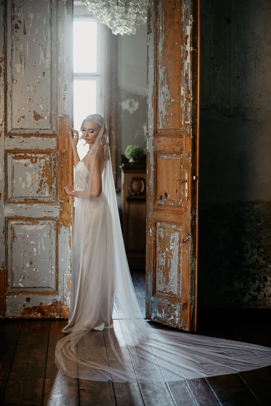 Bride wearing the Marlena Juliet cap veil — vintage-inspired wedding veil with Preciosa crystals and pearls, soft English tulle, romantic silhouette.