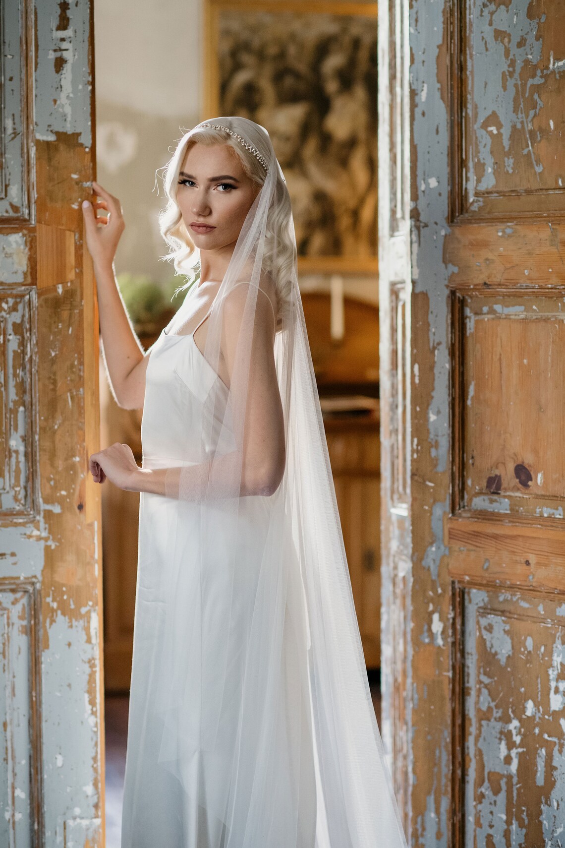 Bride wearing the Marlena Juliet cap veil — vintage-inspired wedding veil with Preciosa crystals and pearls, soft English tulle, romantic silhouette.