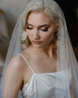 Bride wearing the Marlena Juliet cap veil with delicate pearls and crystals row