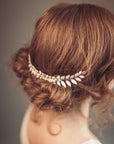 Close-up of ERATO bridal laurel hair comb showing enameled leaf and pearl details