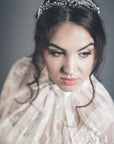 Close-up view of the silver lily of the valley crown on a bride, showing the delicate floral details and clear crystals.