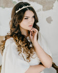 Model wearing ERDME pearl and crystal tiara in ivory cream with gold headband