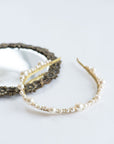 Close-up of delicate pearl and crystal bridal tiara details
