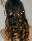 Bride wearing pearl hair pins in updo, minimalist bridal hairstyle with ALSA pins