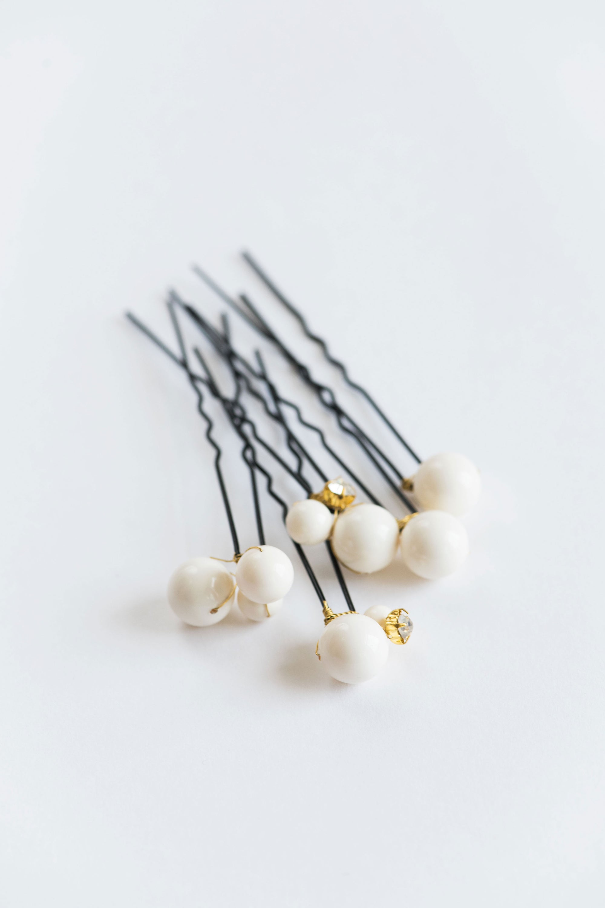 Set of ALSA large pearl hair pins on white background