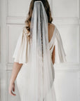 Bride wearing AUGUSTE pearl wedding veil with scattered pearls on soft Italian tulle, modern one-tier bridal look