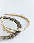 Handmade pearl bridal tiara with crystal accents on neutral background studio flat lay