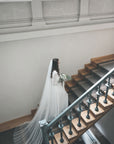 Bride wearing HARRIET wide cathedral veil made of soft English tulle, flowing in natural light