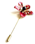Red flower-shaped brooch on a white background