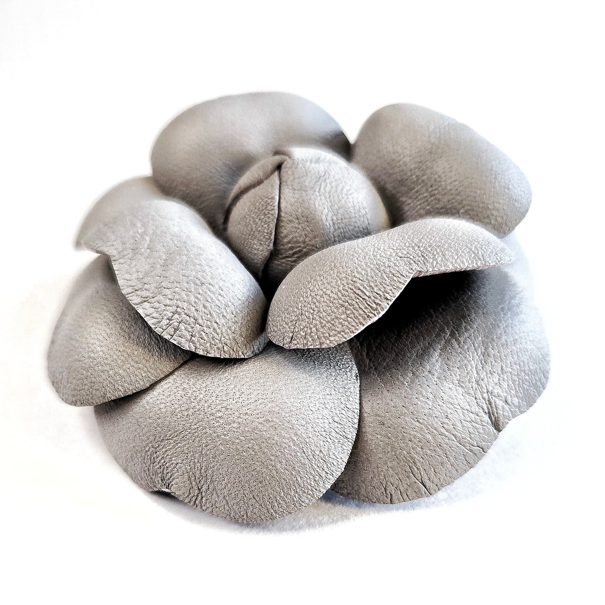 Grey leather camellia brooch with sculptural layered petals and matte finish
