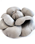 Grey leather camellia brooch with sculptural layered petals and matte finish