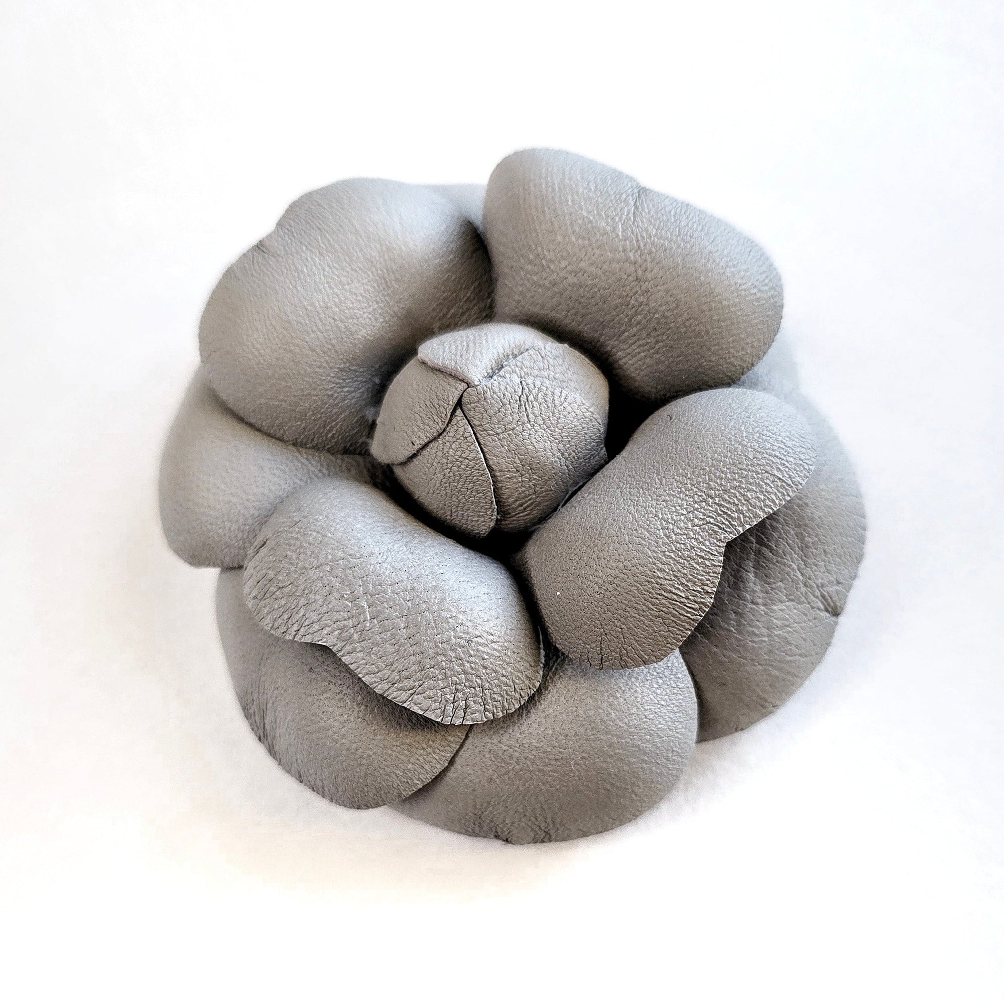 Grey leather camellia brooch with sculptural layered petals and matte finish