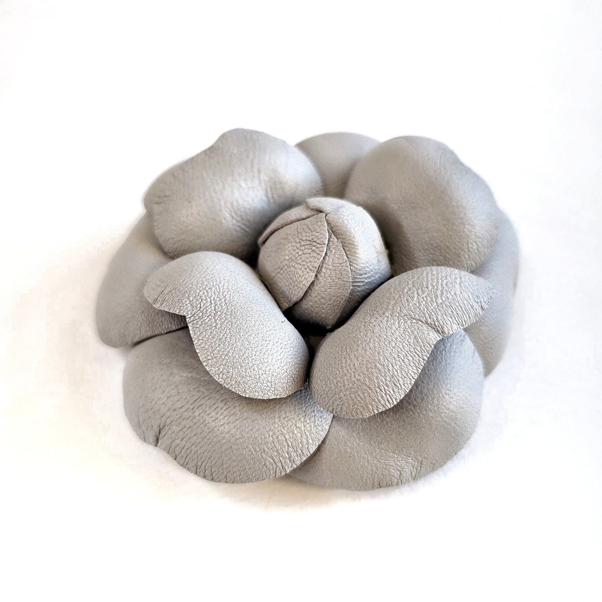 Grey leather camellia brooch with sculptural layered petals and matte finish