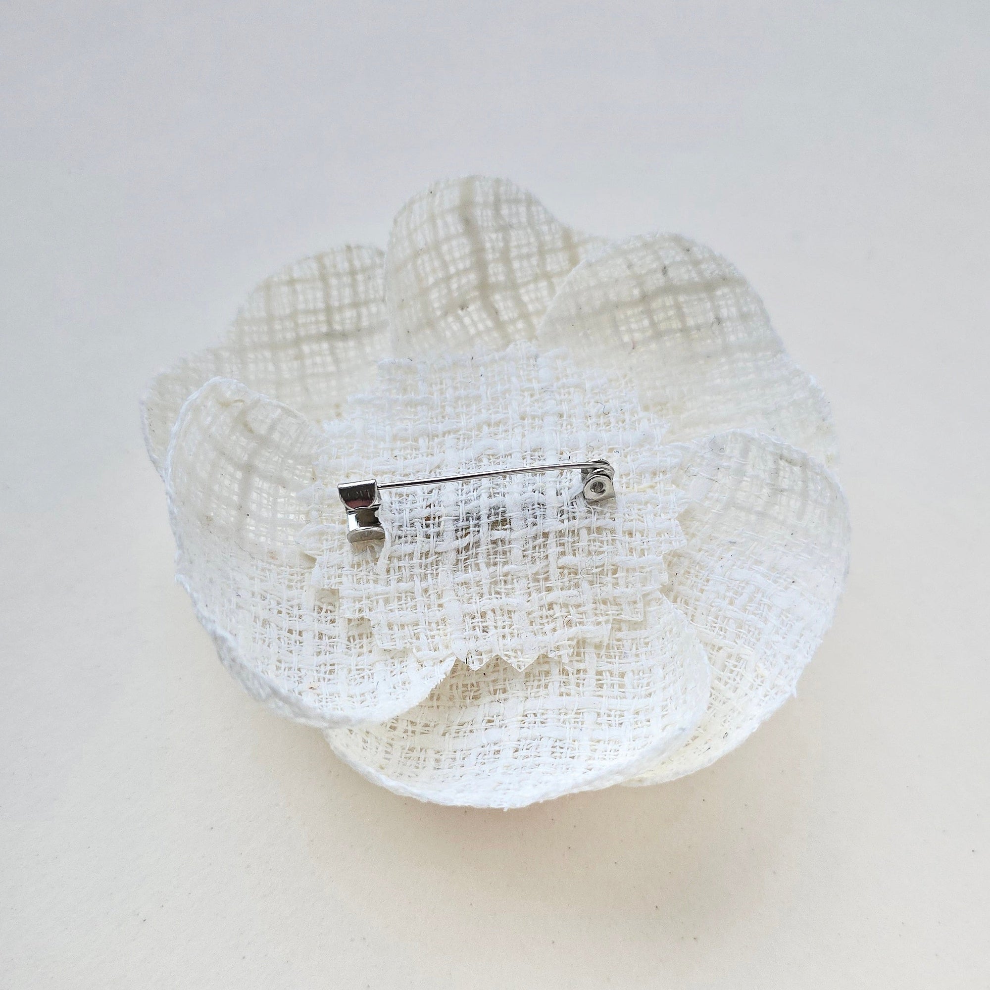 Ivory camellia brooch with pin fastening on back