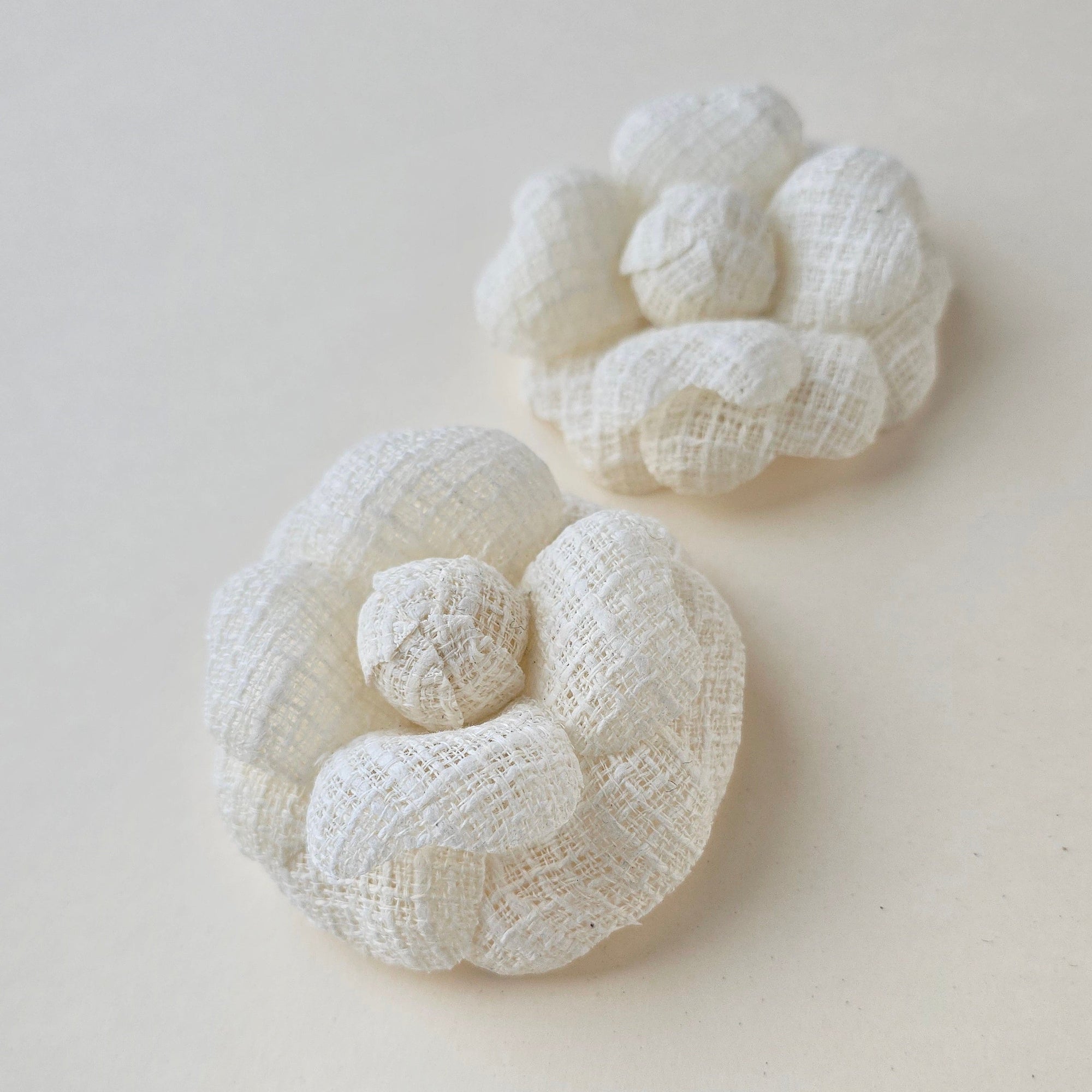 Set of ivory camellia brooches in different sizes