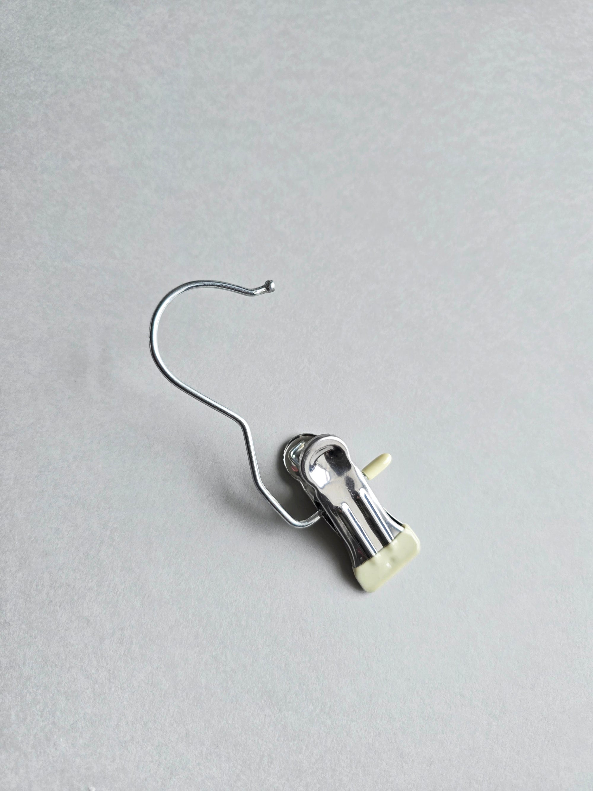 Detailed shot of the high-tension silver metal clip and hook, designed to hold delicate wedding tulle without snagging.