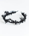 Top view of the LZZY black laurel leaf tiara, showcasing the symmetrical matte black leaf arrangement on a flexible headband.
