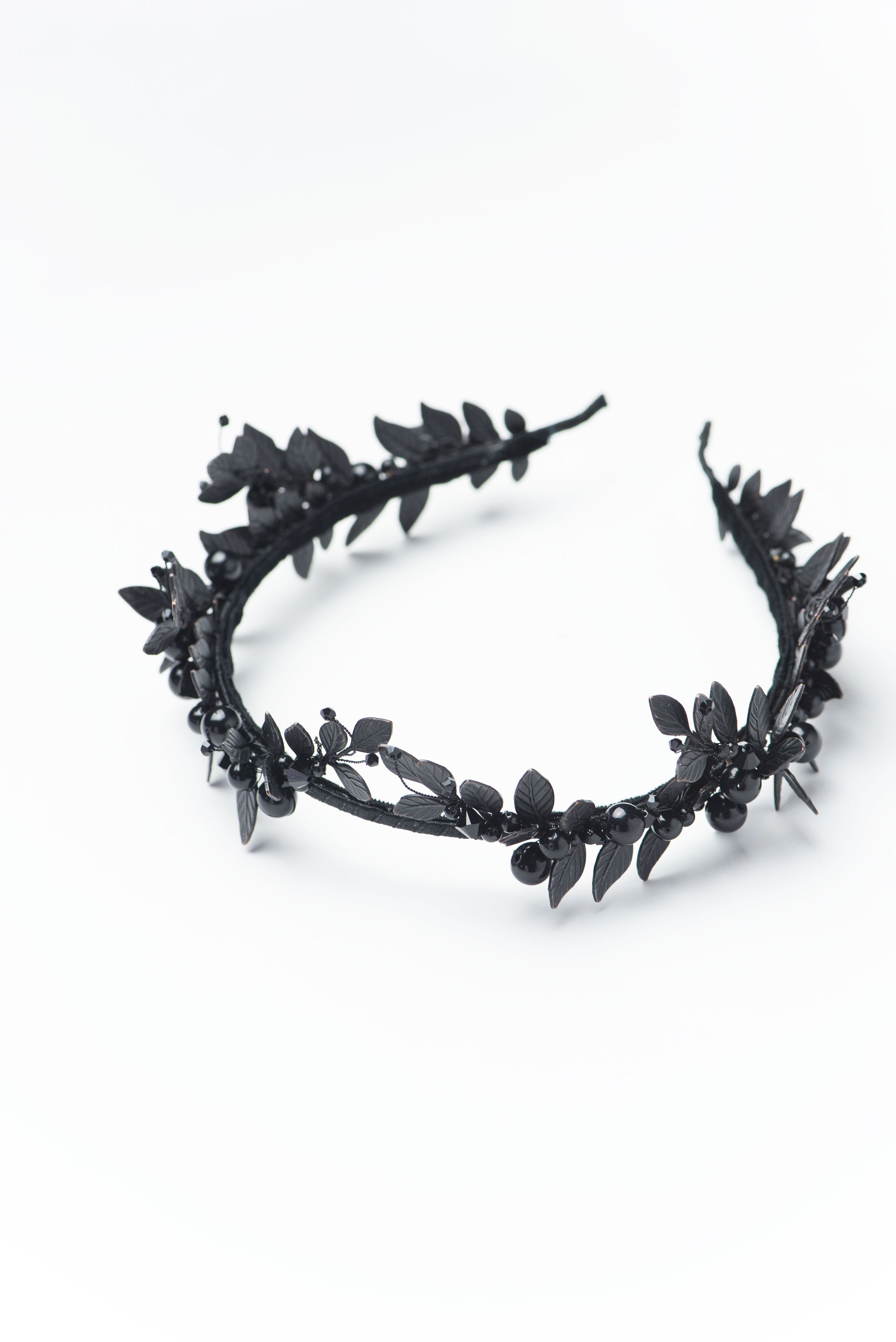 Frontal perspective of the LZZY black tiara on a bride, demonstrating how the architectural leaves frame the face without overwhelming it.