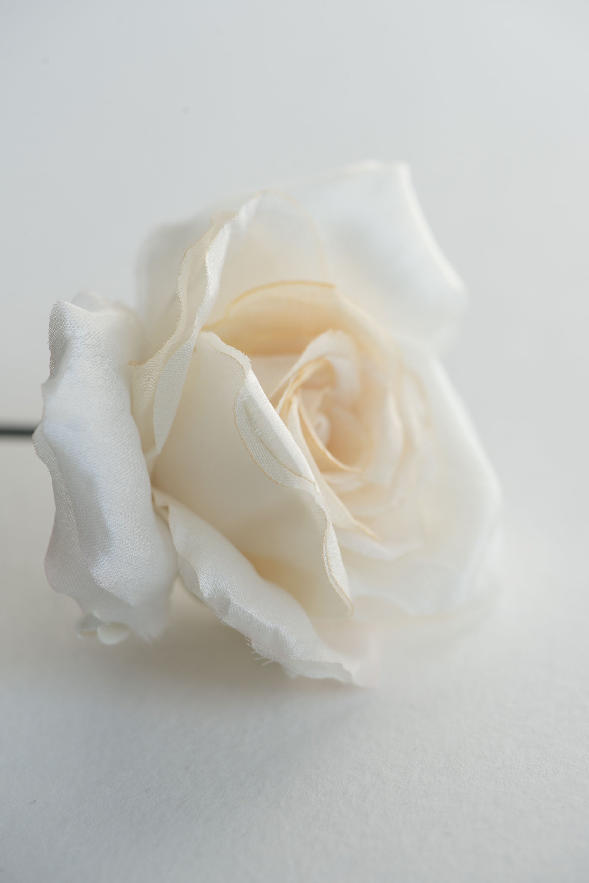 Close-up of ivory rose hair flower, handmade with somebana technique