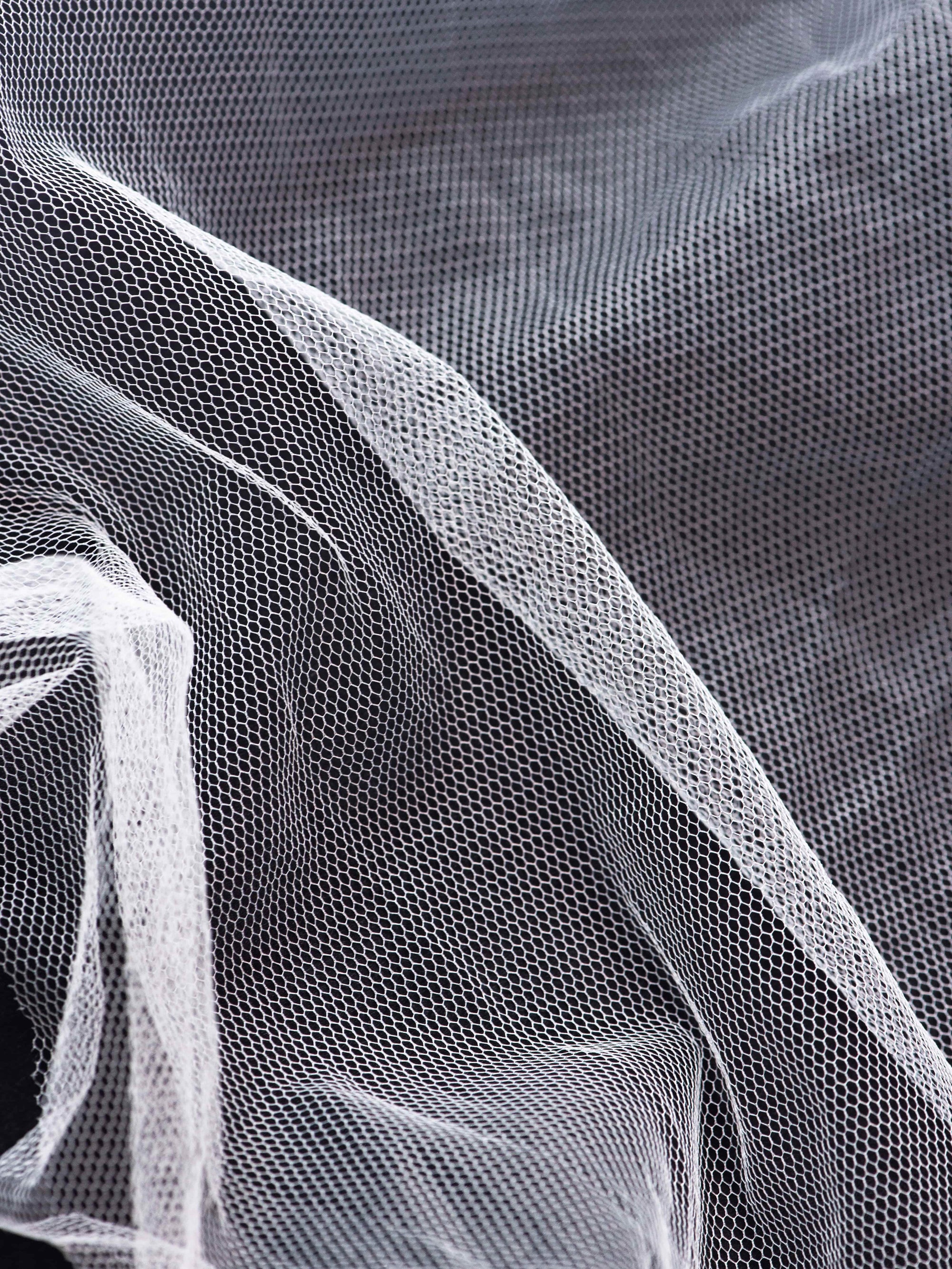 Genuine English tulle fabric close-up hexagonal weave texture