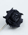 Close-up of matte black cotton velvet rose petals, handcrafted with traditional millinery tools.