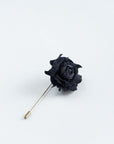 Black rose lapel pin on a white background