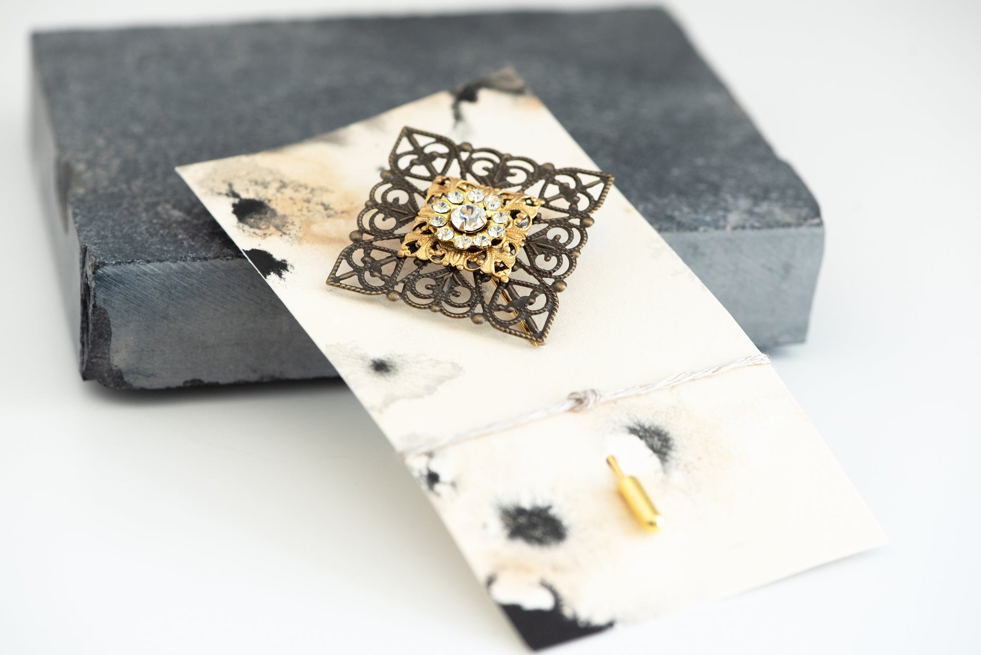 VERITAS sacred geometry wedding boutonniere in brass with glass crystals