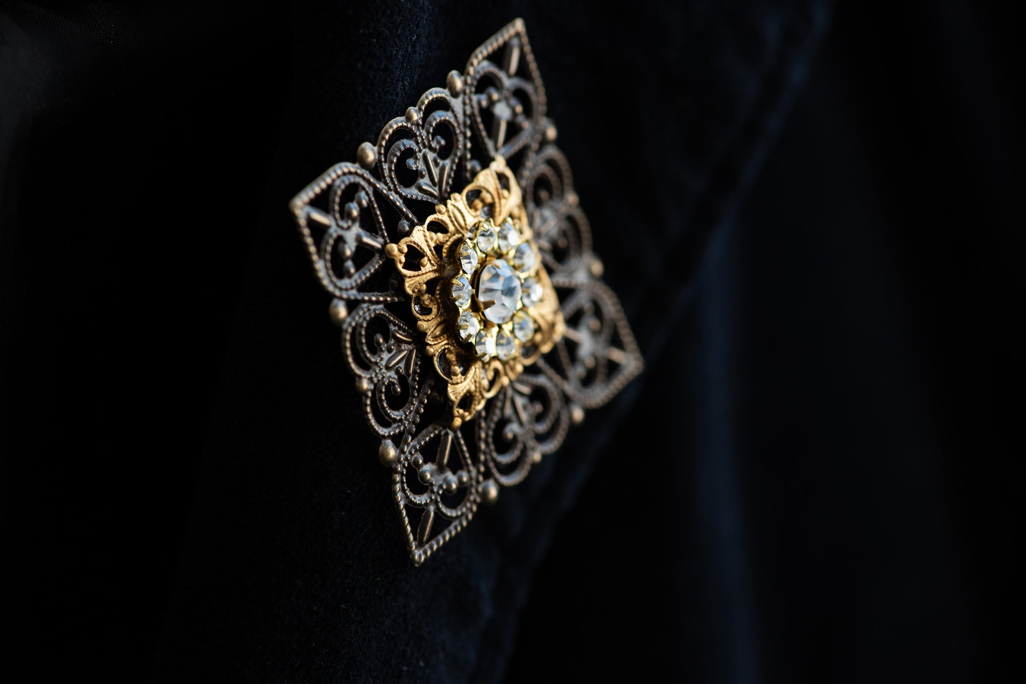 Close-up of filigree and crystal arrangement on VERITAS boutonniere