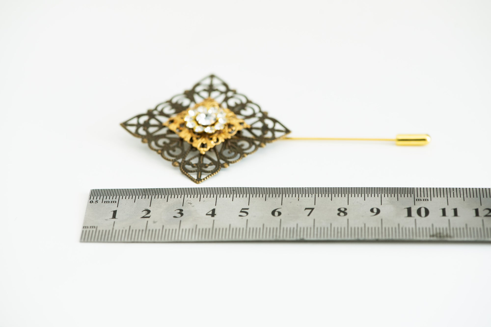 VERITAS sacred geometry wedding boutonniere in brass with glass crystals