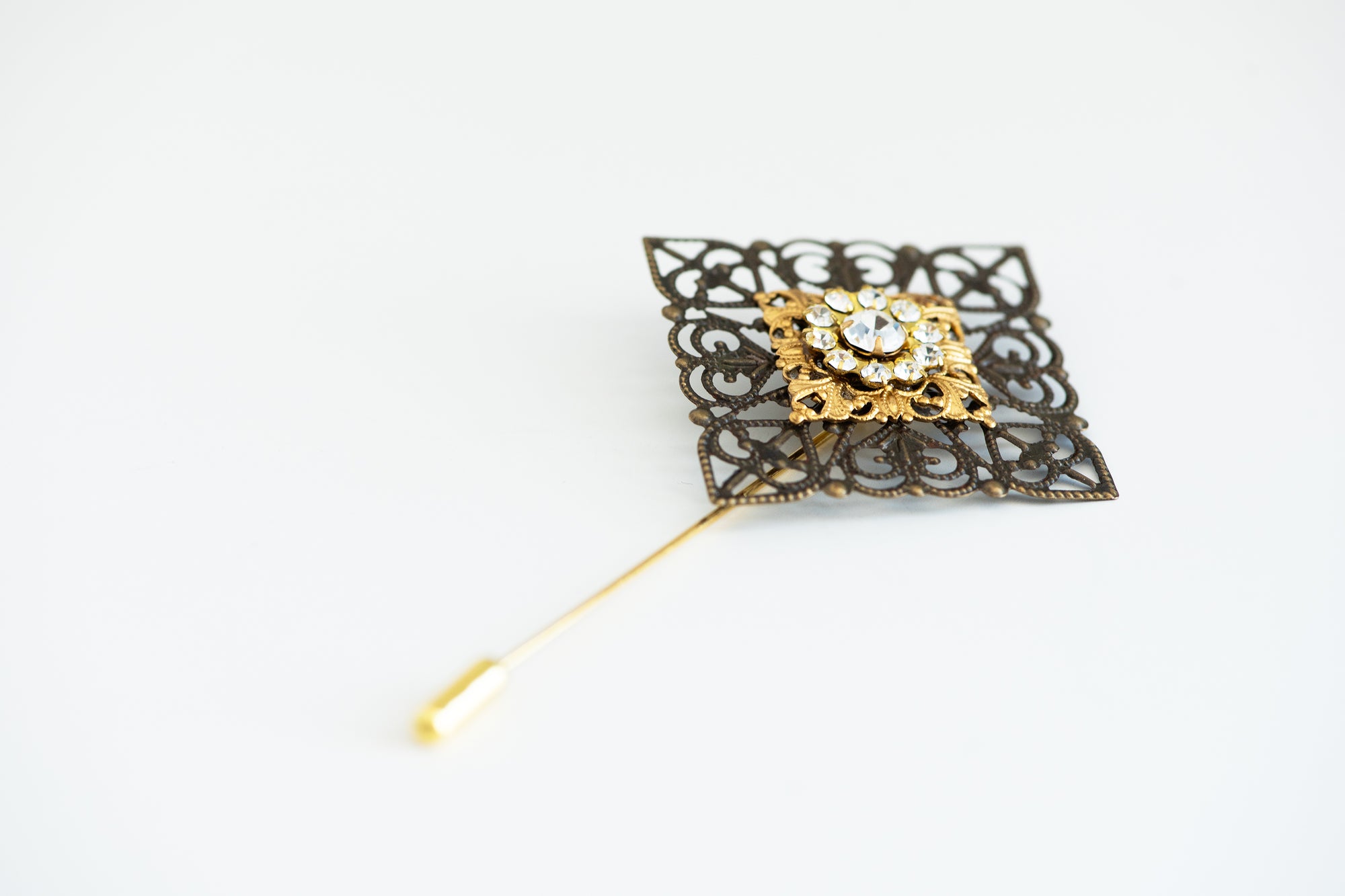 VERITAS sacred geometry wedding boutonniere in brass with glass crystals