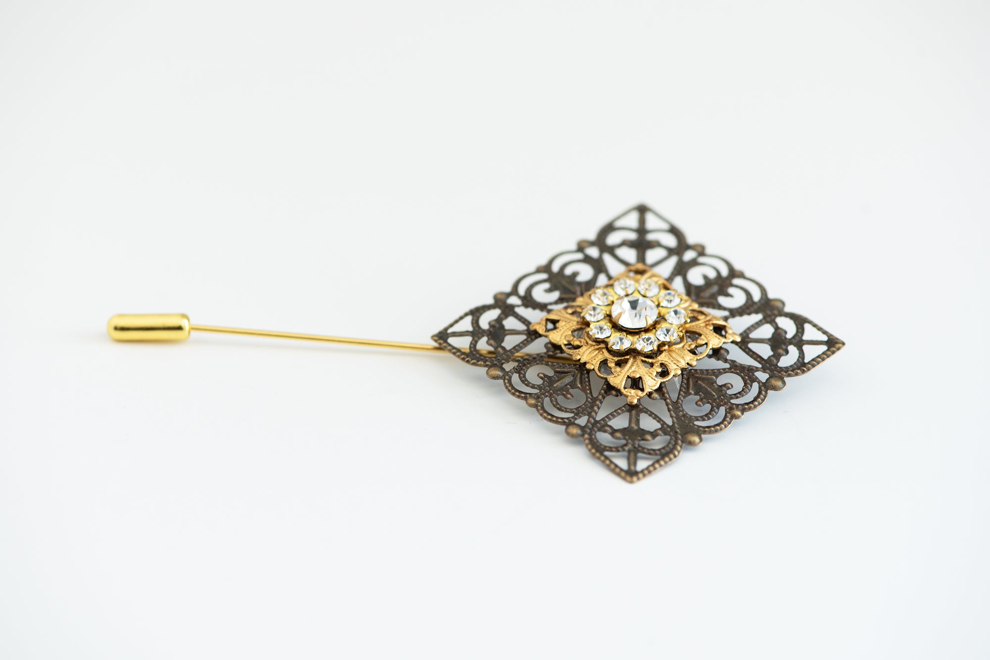 VERITAS sacred geometry wedding boutonniere in brass with glass crystals