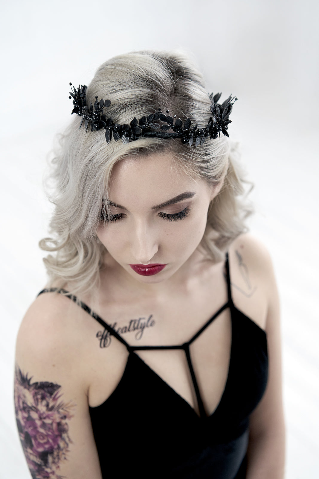 Lifestyle shot of the LZZY black crown integrated into loose wavy hair, showing the lightweight and secure fit of the bridal headband.