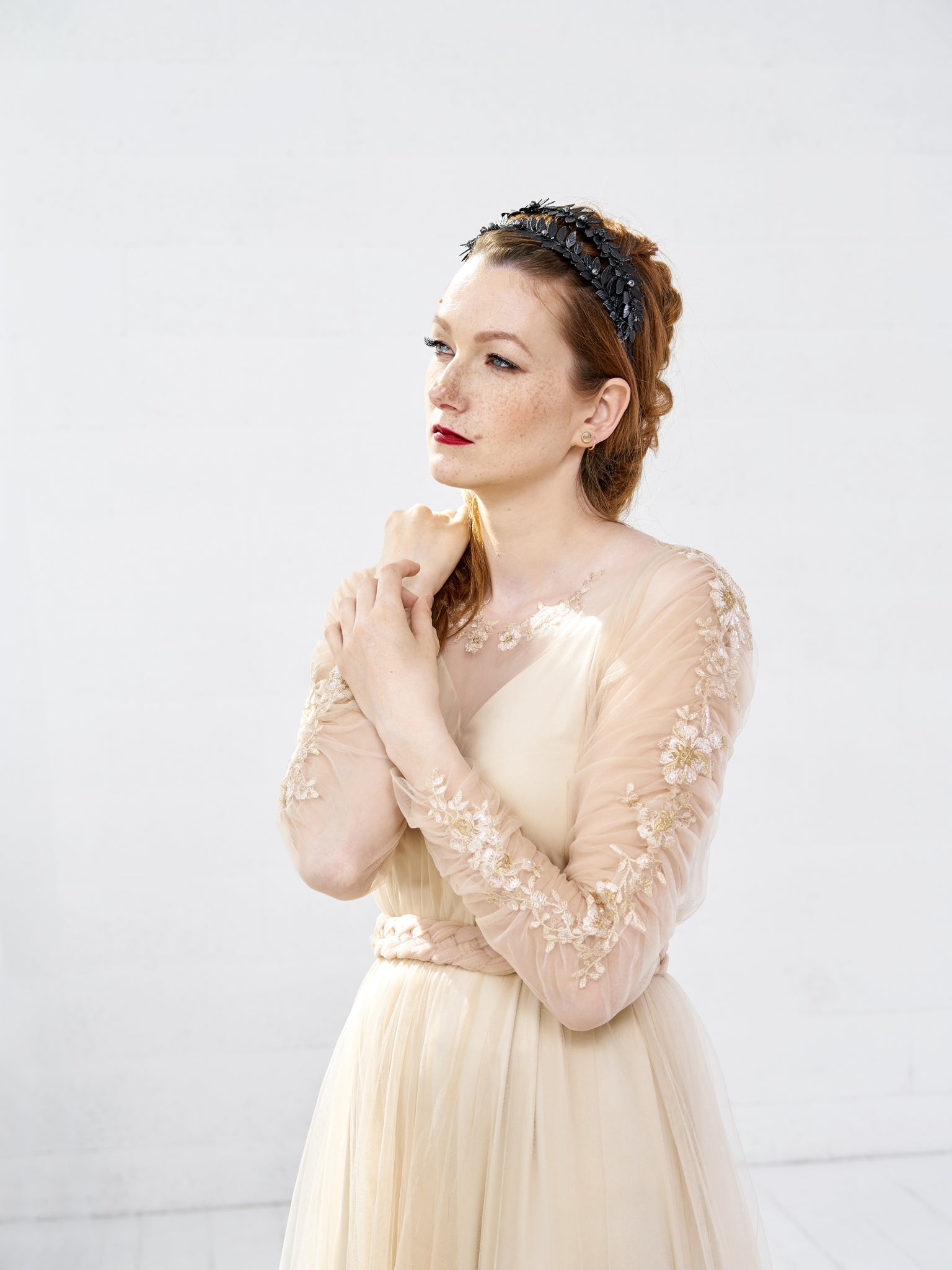 Side profile of a bride wearing the MARIA black gothic tiara with a textured up-do, showcasing the double-row architectural silhouette.