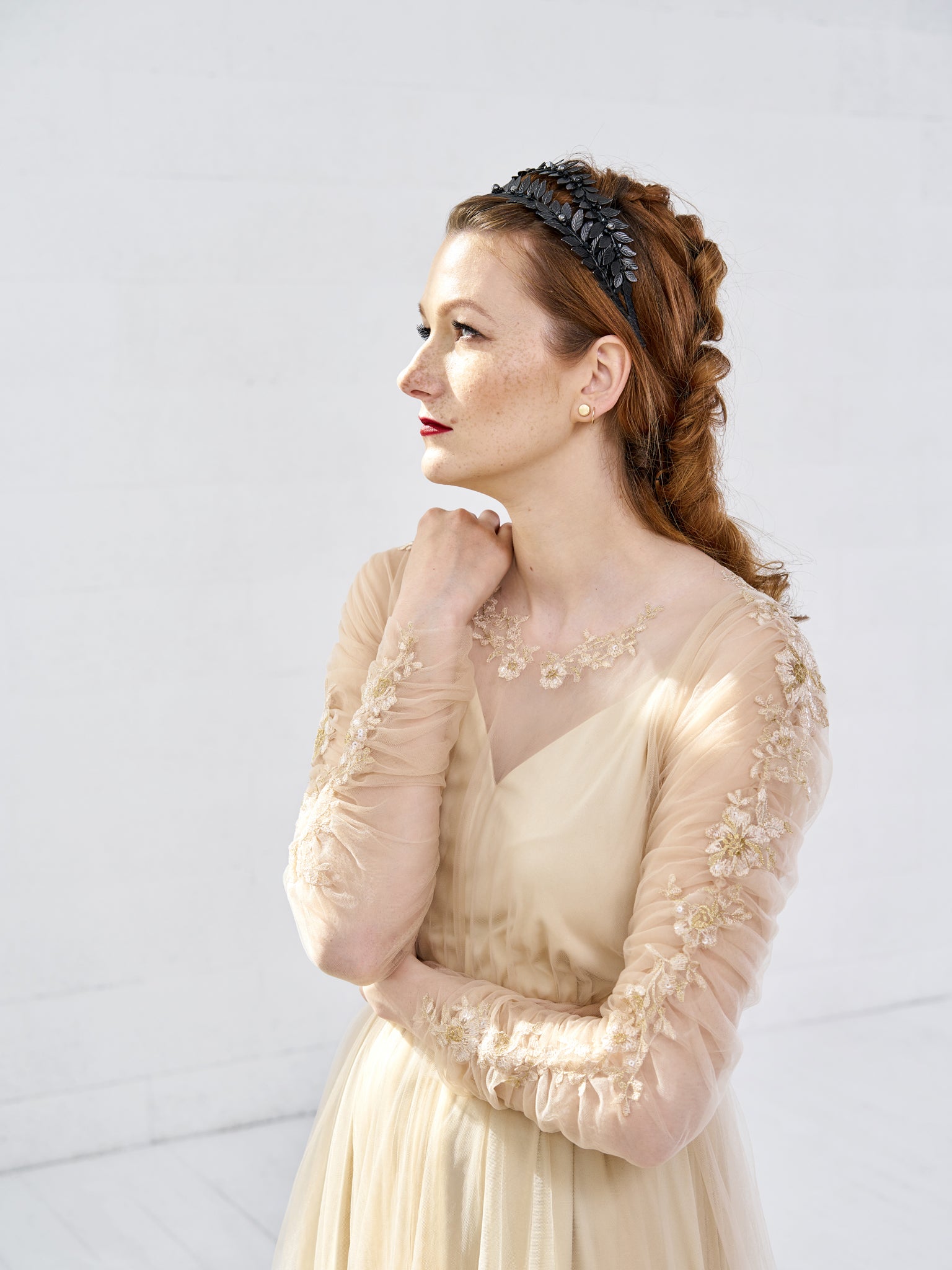 Side profile of a bride wearing the MARIA black gothic tiara with a textured up-do, showcasing the double-row architectural silhouette.