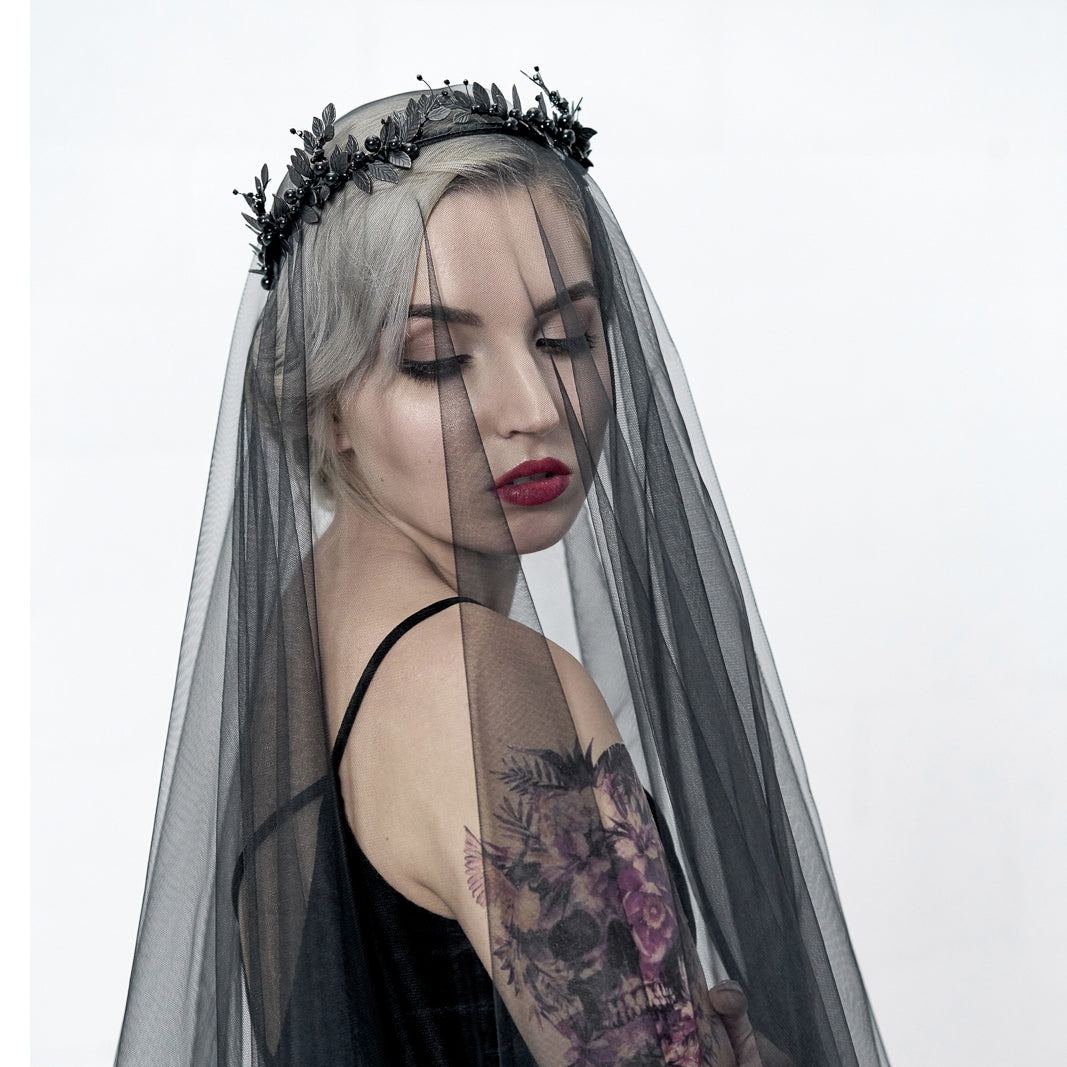 Close-up of LZZY black laurel leaf headpiece in gothic bridal style