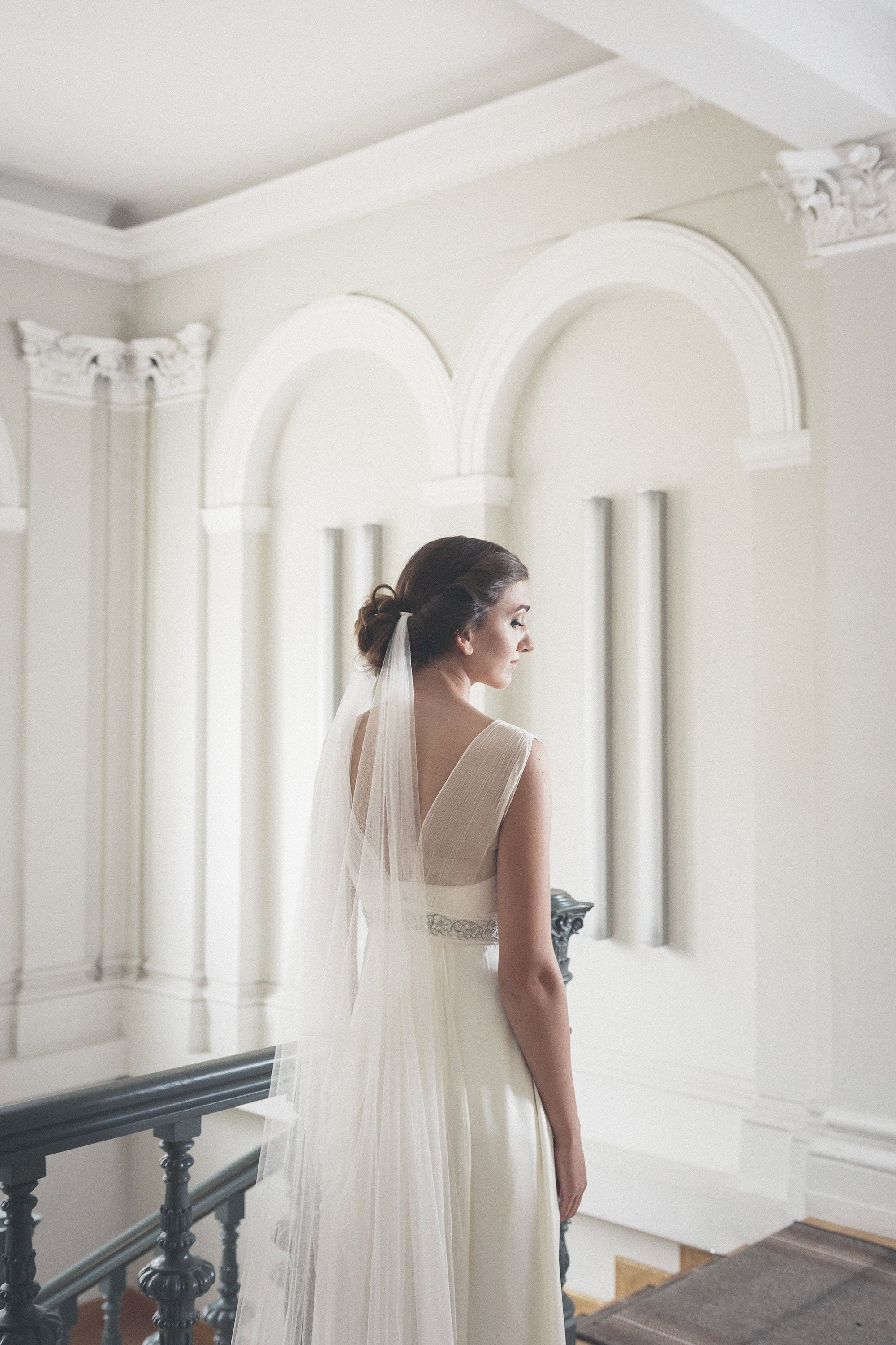 Bride wearing ELIZABETH wedding veil with elegant updo, showing dual comb attachment system
