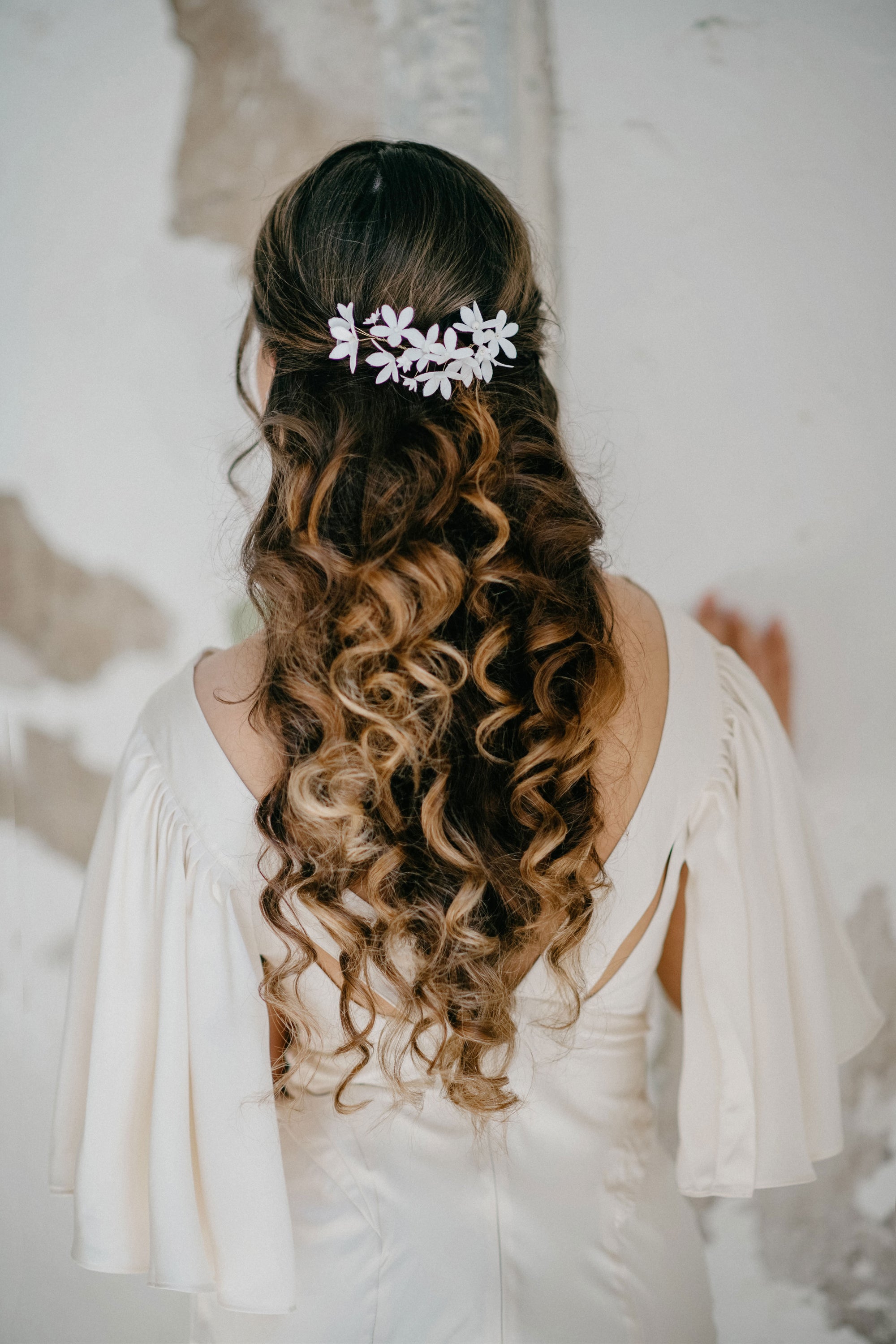Model wearing LIUCINA floral bridal hair vine with white silk velvet flowers and pearls